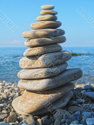 Balanced stones on the seashore summertime