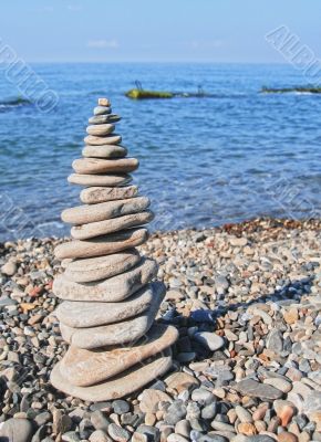 Balanced stones on the seashore summertime