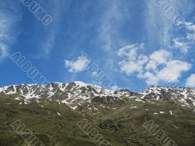 Caucasus mountains under the snow and cloudy sky