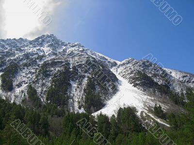 Caucasus mountains under the snow and cloudly sky