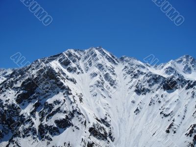 Caucasus mountains under the snow and clear sky