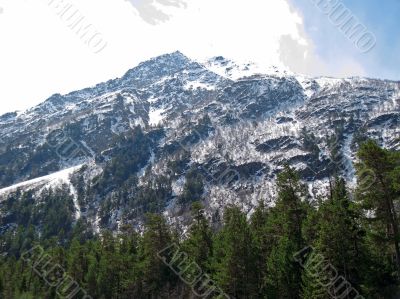 Caucasus mountains under the snow and cloudly sky