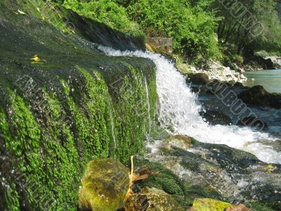 Low and wide waterfall. Abhazia travel