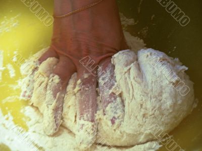 Woman hand push the dough