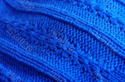 Knit woolen texture. Fabric blue background 
