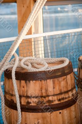 Barrel and rope on sea background