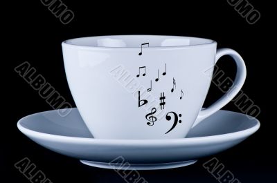 White cup with black musical notes 
