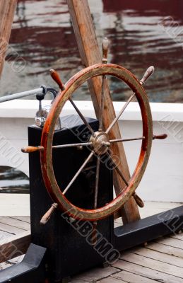 Wooden steering wheel on old sailboat