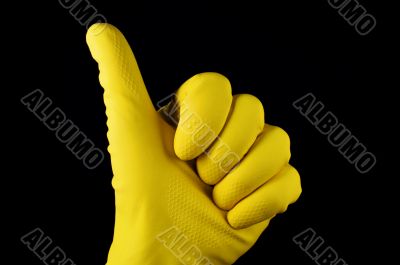 Thumb up in yellow rubber glove