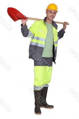 Man holding spade over shoulder