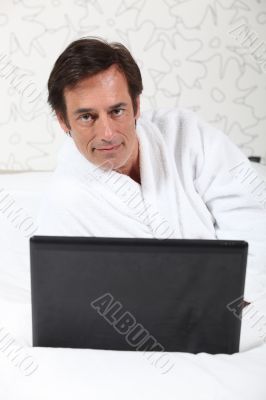 Man working in dressing gown.