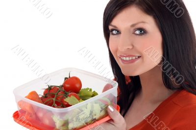 Woman with a plastic lunch box of fresh vegetables