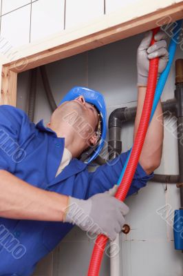 Skilled technician repairing canalizations