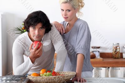 a couple in the kitchen