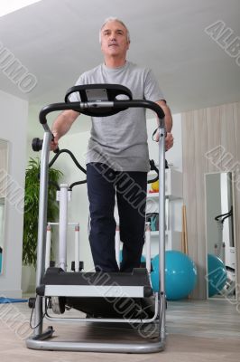 Middle-aged man on treadmill at home