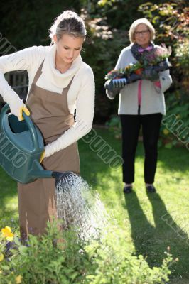 Woman gardening with her grandmother