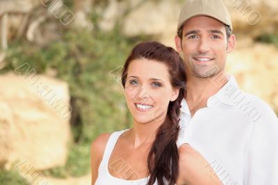 Couple stood outdoors by rocks