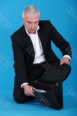 Businessman opening his briefcase