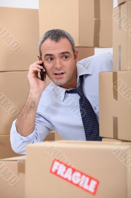 Cellphone user surrounded by boxes