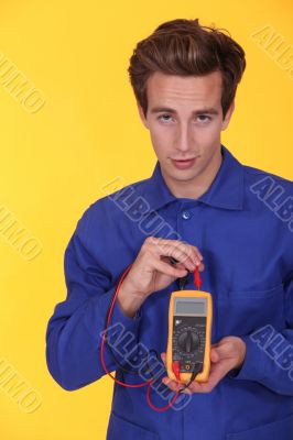 Electrician using a multimeter