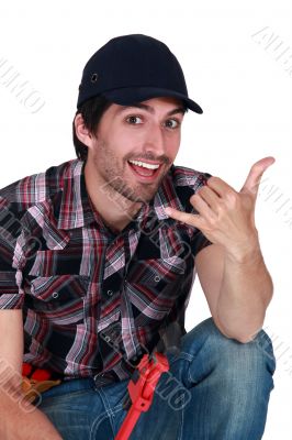 A male construction worker making a hand sign. A male construction worker making a hand sign.