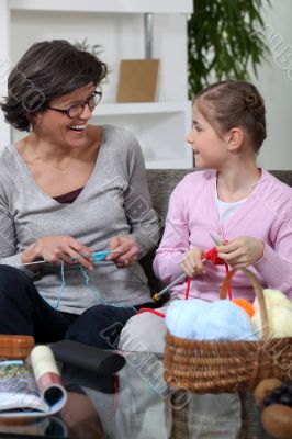 Grandmother knitting with her granddaughter