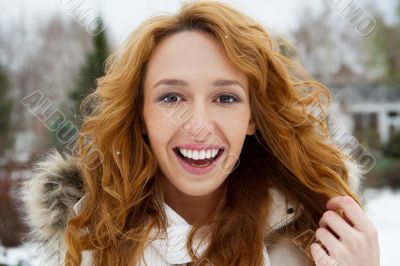 Portrait of young pretty woman in winter park