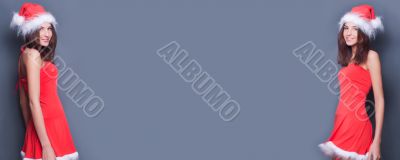 Portrait of two young twins women standing against each other. 