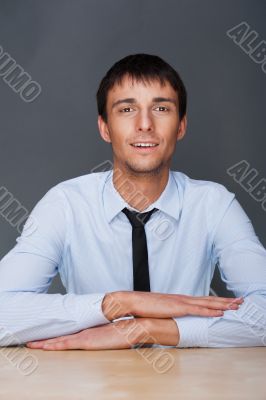 Portrait of young business man on a desk. 