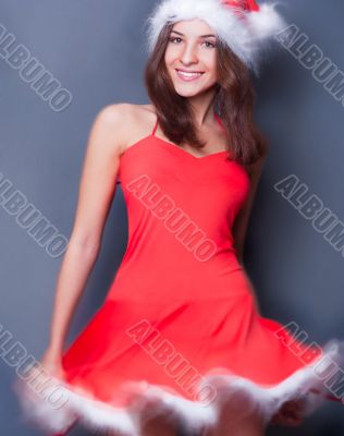 20-25 years od beautiful woman in christmas dress dancing .