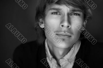 Portrait of young man with smart and wise look. Looking at camera.