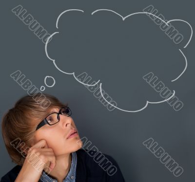 Image of young man thinking of his plans. Lots of copyspace inside graphic cloud for your text.
