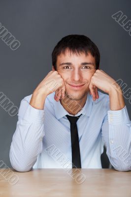 Portrait of young business man on a desk playing the ape