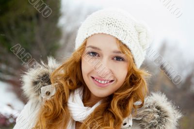 Portrait of young pretty woman in winter park