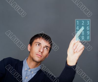Portrait of adult business man pressing a touchscreen button whi
