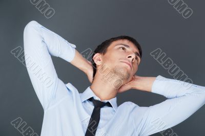 Portrait of relaxed business man against grey background. Daydre