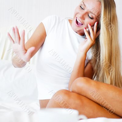 Happy young woman boasting to her friends about  her proposal ri