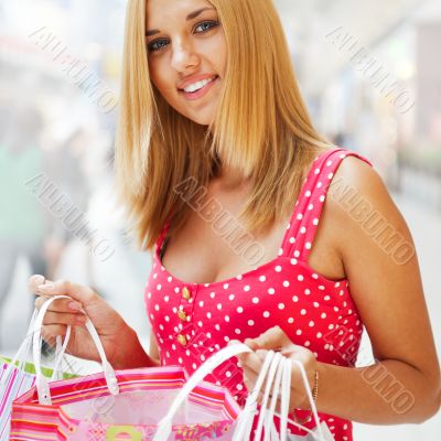 Beautiful woman at a shopping center with bags and smiling