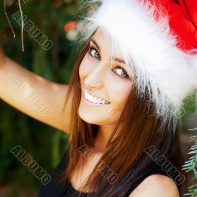 Portrait of a sexy young female smiling in a park and looking at