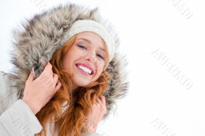 Young pretty woman enjoying herself at winter park. Laughing and