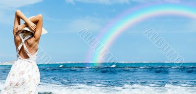 Young fashionable woman wearing hat and sophistical dress on the