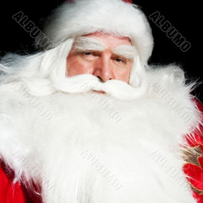 Santa Claus portrait smiling isolated over a black background