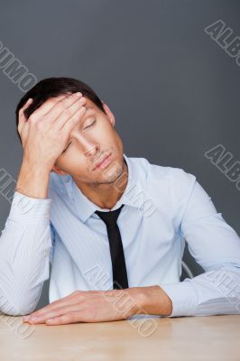 Closeup of a young business man having a stress. Headache. Again