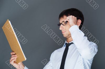 Closeup of a young smiling business man standing confidently aga