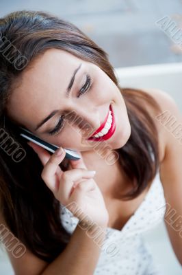 Closeup portrait of a pretty young female sitting at cafe in mor