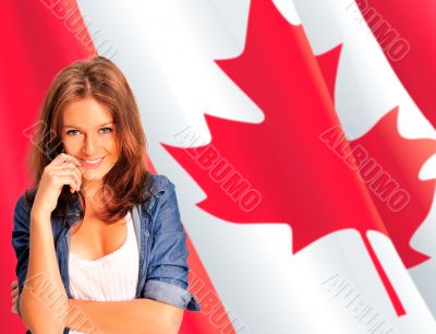 Portrait of a pretty young woman against a Canadian flag , smili