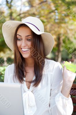 Young elegant woman wearing straw hat and white dress holding cr