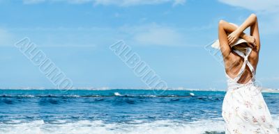 Young fashionable woman wearing hat and sophistical dress on the