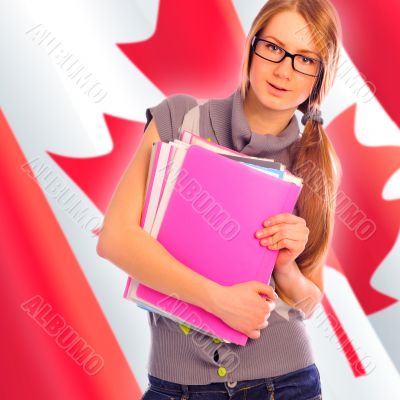 Portrait of pretty young woman holding book in her arms. Canadia