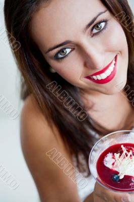Portrait of an young beautiful woman eating an ice cream in cafe